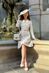 a lady in a tweed patchwork lapel dress with a belt